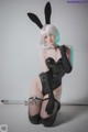 A woman in a bunny costume posing for a picture.