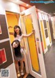 A couple of women standing next to each other in a hallway.